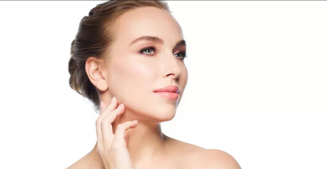 A woman with her hand on the side of her face.