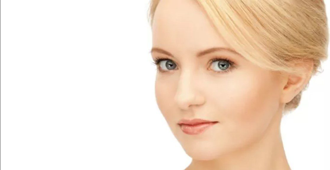 A woman with blonde hair and green eyes.