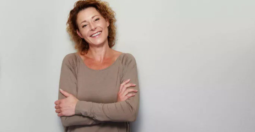 A woman standing with her arms crossed.
