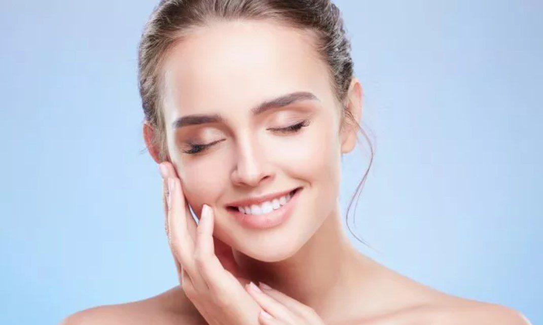 A woman with her hands on her face.